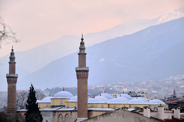 Bursa during overcast and rainy day. Photo taken from tophane district through grand mosque (ulu camii) built by ottoman empire and with ulu mountain (uludag) background.