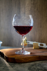Red wine with blue cheese isolated on the wooden board in a rustic glass