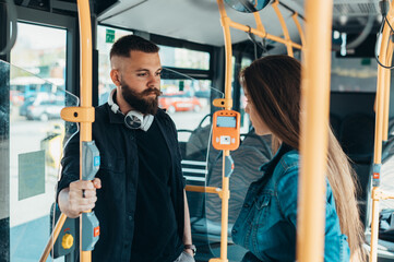 Young couple looking at each other in the bus