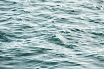 Texture of glitter water and soft waves. sparkling in water - background. sea water with sun glare...