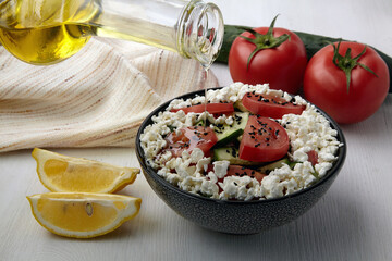 Salad with chopped tomatoes and cucumbers, cottage cheese and black cumin seeds