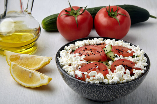 Salad with chopped tomatoes and cucumbers, cottage cheese and black cumin seeds