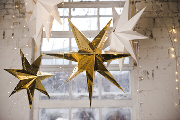 Big golden star, ornaments and holiday decorations. Shiny stars. Party decor