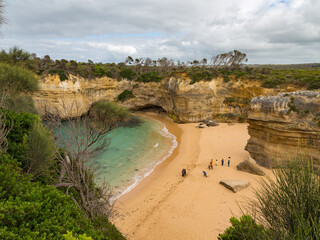 Tiny Figures in a Secret Cliff-Lined Cove on the Great Ocean Road, Port Campbell National Park, Australia