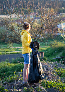 volunteer collecting plastic garbage Earth day