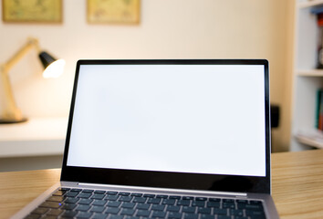 Blank laptop screen on an office desk.