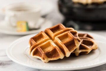 Freshly baked belgium waffles served in white plate
