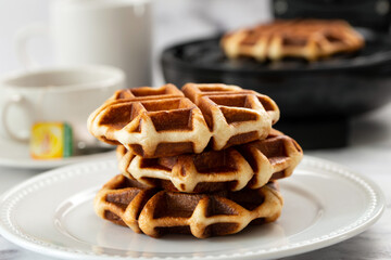 Freshly baked belgium waffles served in white plate