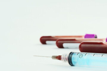 Vacuum tubes for collection and blood samples on white background..Transparent with purple and...