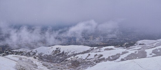 Downtown Salt Lake City View from Little Black Mountain Peak winter snowscape mountain hiking trail views via Bonneville Shoreline Trail, Wasatch Front Rocky Mountains, Utah. United States.