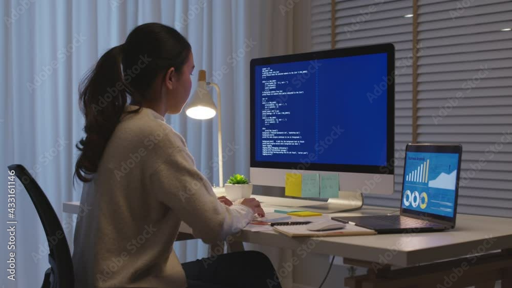 Wall mural back view young asia female people analyst coder code language multiple screen cloud online computin