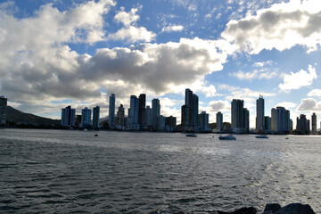 Beach with sand, rocks and green under a blue sky