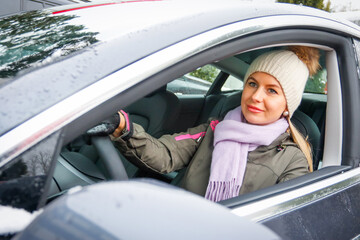 Beautiful woman driving the electric car. 