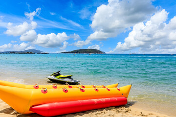 Yellow banana boat by the blue sea.