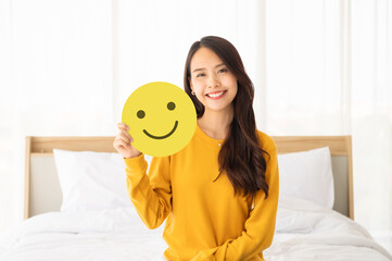 Customer service experience and business satisfaction survey. Asian woman holding paper with smiley...