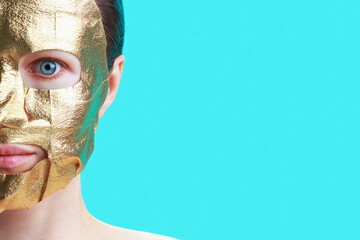 Portrait of young woman with golden mask on face, skin care concept.