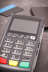 Obraz premium Payment terminal with credit card and mobile phone. Cashless paying for shopping. Finance concept