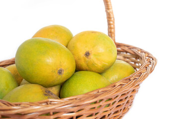 indian mangos in a basket on a white background in close up view