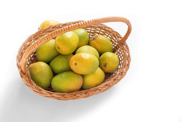 indian mangos in a basket on a white background in top view