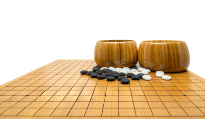 Isolated Go board game or traditional Chinese ancient board game, black stones, white stones and two wooden bowls are put on board, low angle and perspective view, image on white background.