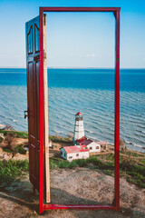 Fototapeta na wymiar View through the open door to the lighthouse and the sea