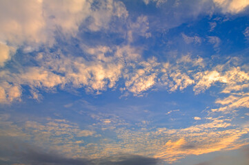 Obraz premium Beautiful morning. Blue sky and golden clouds.