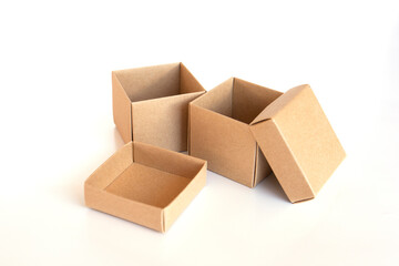 Opened brown cardboard box with lid on white background