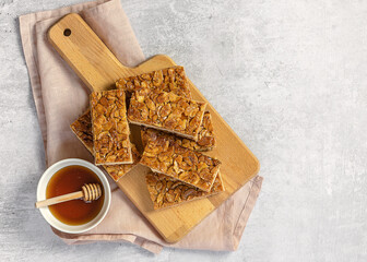 Almond florentines or Bee sting, thin shortbread covered cookies with honey. light concrete background, copy space