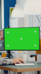 Videographer using computer with chroma key, mock up isolated display editing video and audio footage. Man editor processing film montage on pc with green screen while team working in background