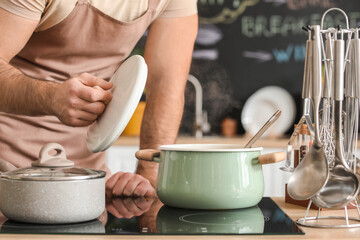 Young man cooking in kitchen