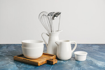 Set of kitchen utensils on color background