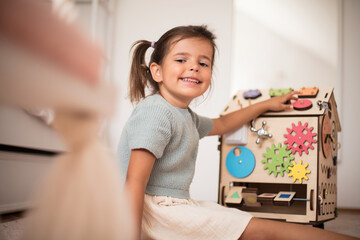 Toddler playing interactive games for good development at home.