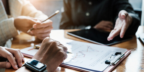 Fund managers team discuss, researching and analysis Investment stock market by paperwork.