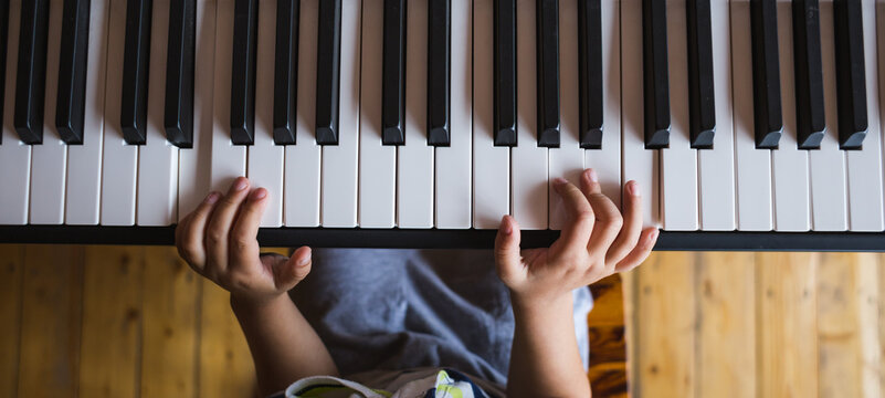 A child learns to play the piano.