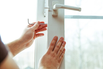 window repair service. adjustment of plastic windows close-up