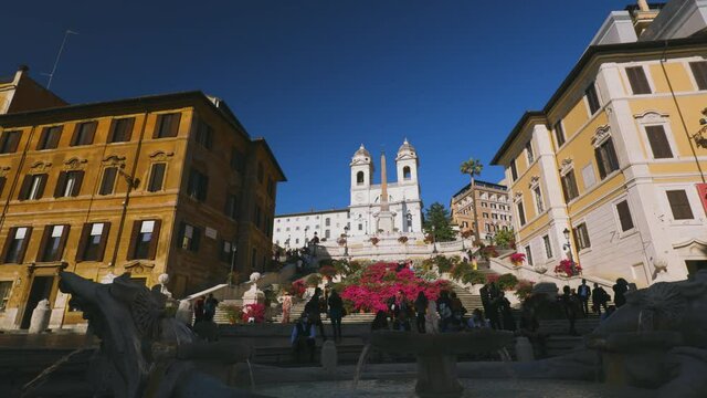 View of the Fountain of Barcaccia and Spanish Steps during a spring day