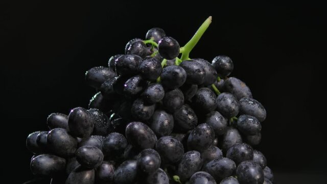 Fresh grapes rotation on black background. Grapes close up. 