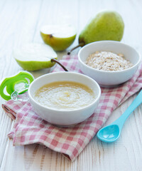 Bowl with fruit baby food and pears