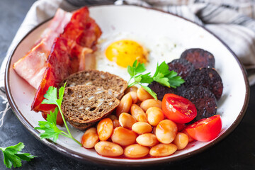 english breakfast fried egg black pudding blood sausage, cereal bread, beans scrambled eggs, on the table wholesome food healthy meal snack copy space food background rustic. top view