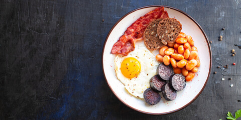 english breakfast fried egg black pudding blood sausage, cereal bread, beans scrambled eggs, on the table wholesome food healthy meal snack copy space food background rustic. top view