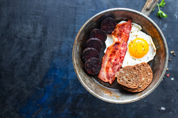 english breakfast fried egg black pudding blood sausage, cereal bread, beans scrambled eggs, on the...
