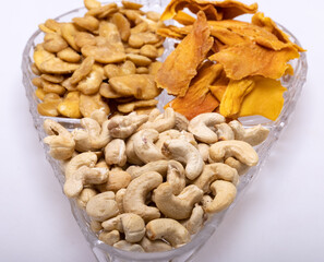 Roasted and salted fava beans, cashew nuts and dried mango slices for a healthy vegan and vegetarian diet snack. High in protein, vitamins, dietary fibre and nutrients