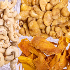 Roasted and salted fava beans, cashew nuts and dried mango slices for a healthy vegan and vegetarian diet snack. High in protein, vitamins, dietary fibre and nutrients