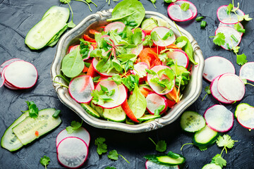 Summer vitamin salad on a metal plate