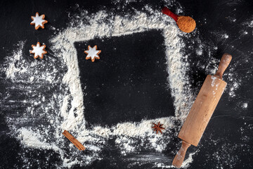 Baking background with a place for text. White flour, rolling pin, and cookies