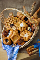 Sweet flour buns on the table in a picnic basket.