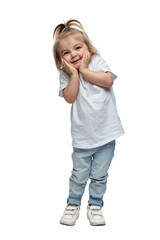 Laughing little girl 2-3 years old in jeans stands and holds her head. Isolated on white background. Verical. Full height.