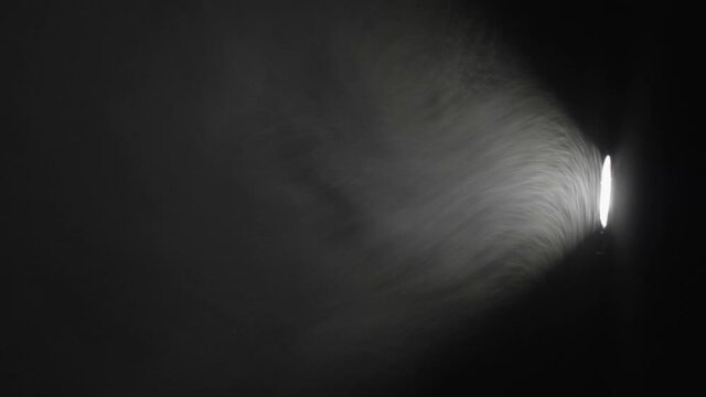 Dust playing in the projector light beam in the dark