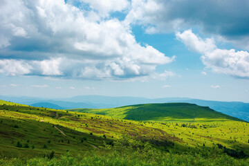 summer landscape in mountains. beautiful view of rolling hills beneath a wonderful sky with white...