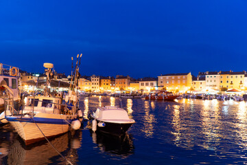 Croatia. City of Rovinj. Popular tourist spot. Summer evening. City pier with fishing and tourist boats